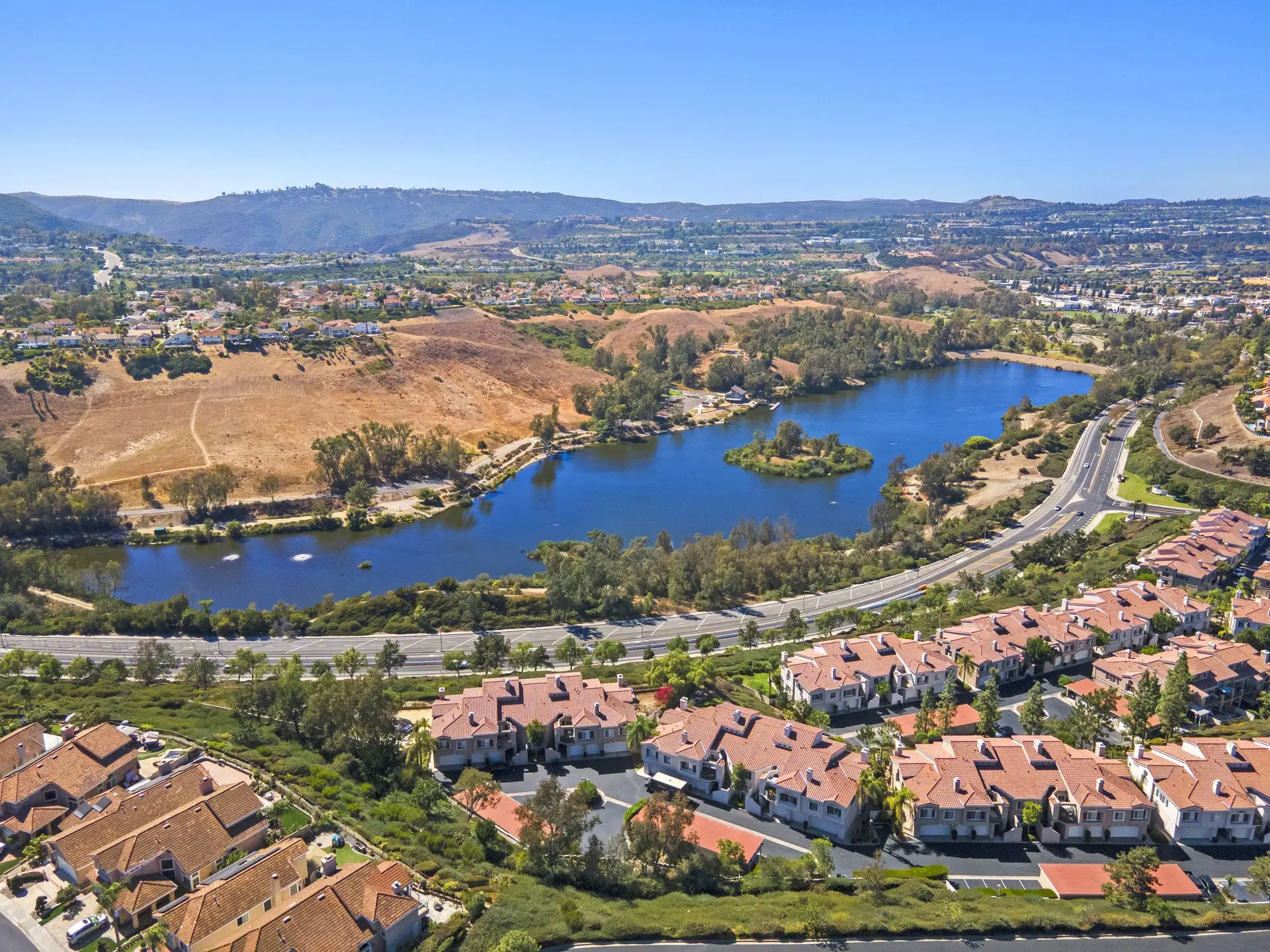 Aerial view of homes beside a lake in the South Orange County hills